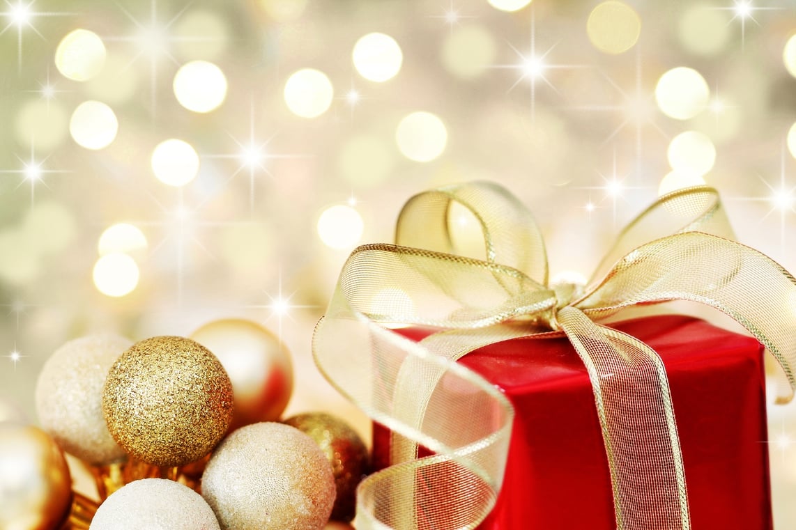 bigstock-Christmas-Gift-On-Defocused-Li-6064726-2